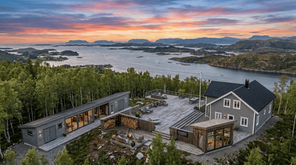 Modern wooden retreat overlooking a mountainous island-studded coastline at sunset